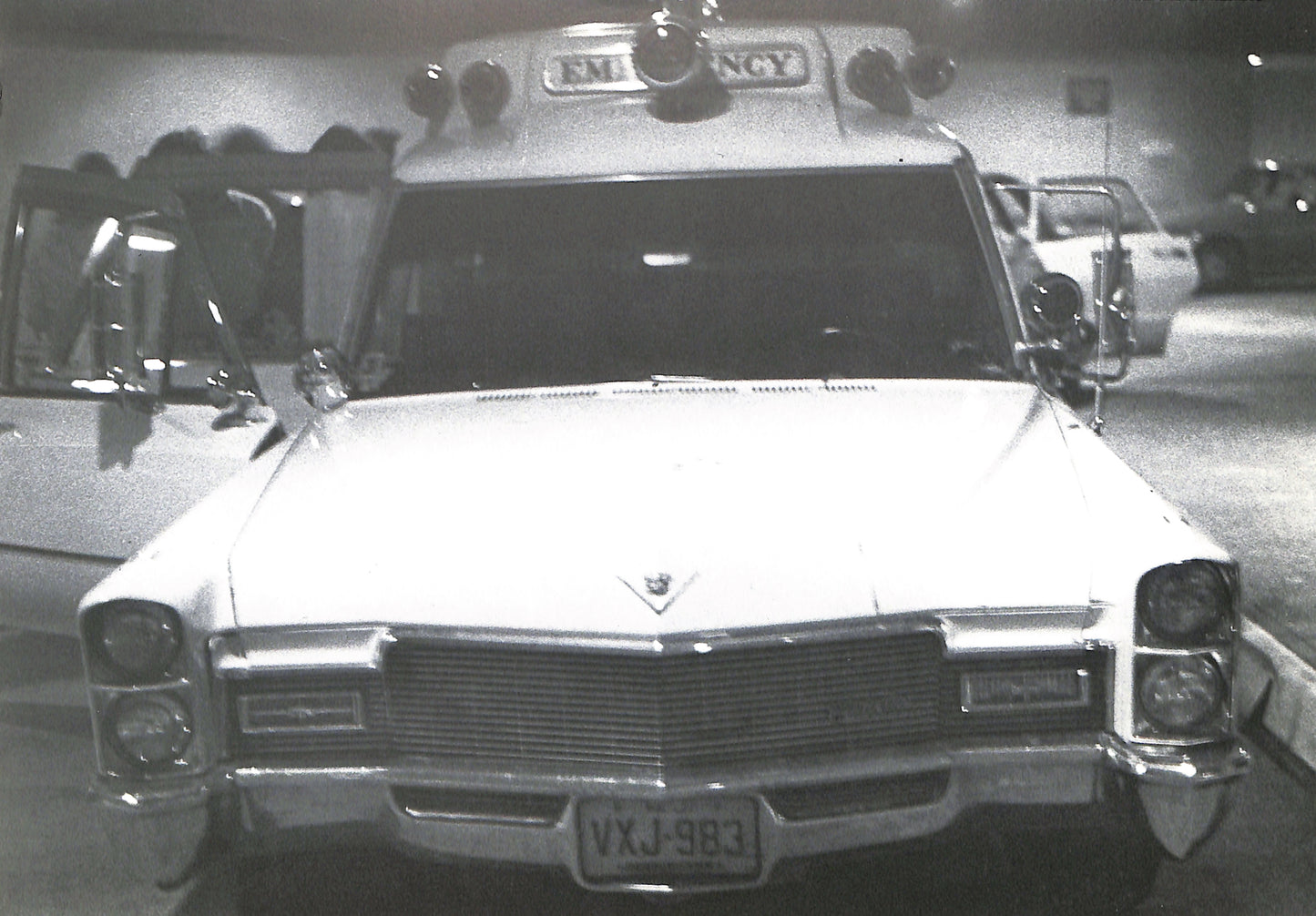 Interior - CAROLINE TISDALL / JOSEPH BEUYS: COYOTE. Vintage ambulance with 'EMERGENCY' sign on top, parked indoors.