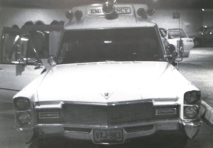 Interior - CAROLINE TISDALL / JOSEPH BEUYS: COYOTE. Vintage ambulance with 'EMERGENCY' sign on top, parked indoors.