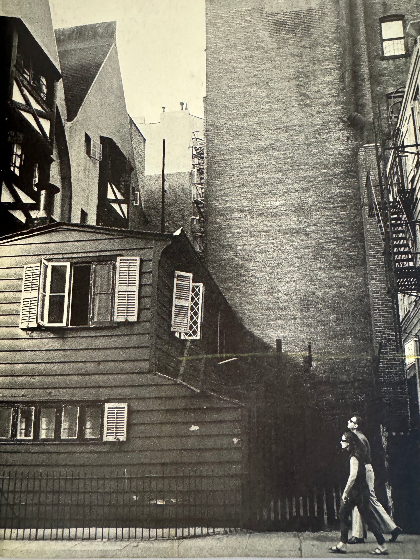 Interior shot - SUMIHARU WATANABE
Face of Washington Square (Washington Hiroba no Kao), 1965.
Black and white photograph of a narrow alleyway between buildings with two people walking.